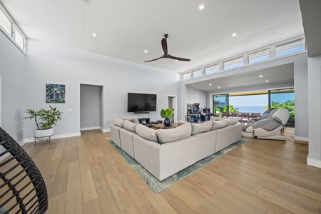 Spacious great room centers around plush sectional and 65-inch Smart TV.