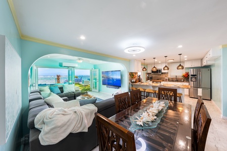 Plush sectional seating with ocean-inspired decor and a large flat screen for relaxing nights.