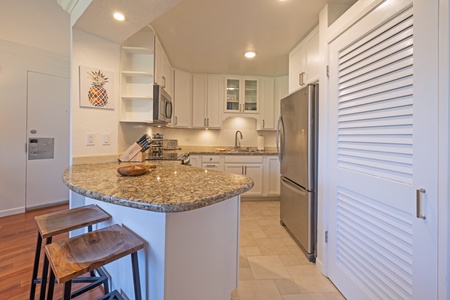 Kaanapali Shores 213 features granite counters and stainless appliances in a sleek kitchen.