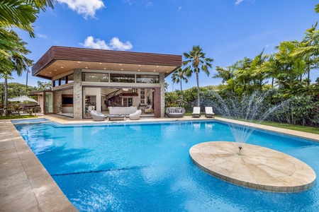 Enjoy a refreshing dip in the crystal-clear pool, surrounded by tropical paradise.