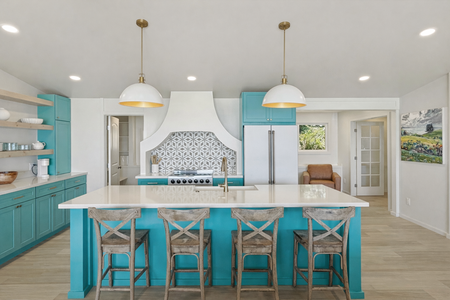 Your unique turquoise kitchen invites culinary adventures with its spacious island, gleaming countertops, and coastal charm that makes every meal memorable.