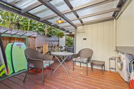 Bonus covered lanai area with outdoor seating and surf gear storage—perfect for post-beach hangs.