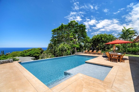 Take a dip in the heated pool and soak in panoramic ocean views surrounded by tropical greenery.