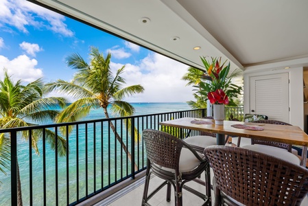 Oceanfront balcony with cozy seat—enjoy a meal or drink while taking in stunning views of the tropical paradise.