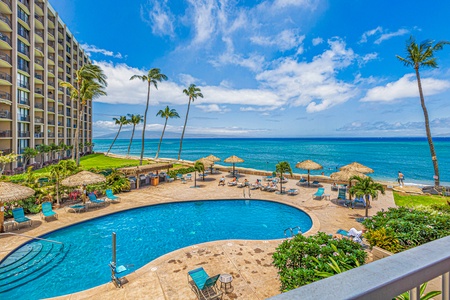Wake up to ocean views from the primary bedroom at Royal Kahana 213, complete with lanai access and a TV.