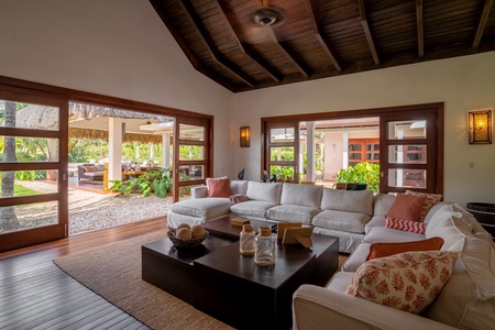Relax in the living area that has plush sectional sofas, high, vaulted ceiling and direct access to the cabana.