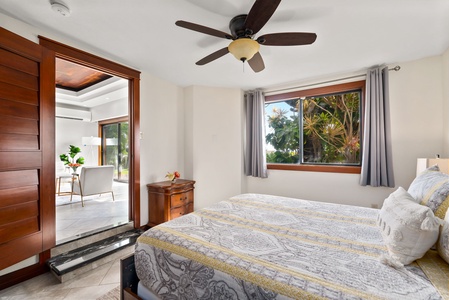 Bright and airy bedroom with a queen-sized bed and sliding doors to the outdoor space.