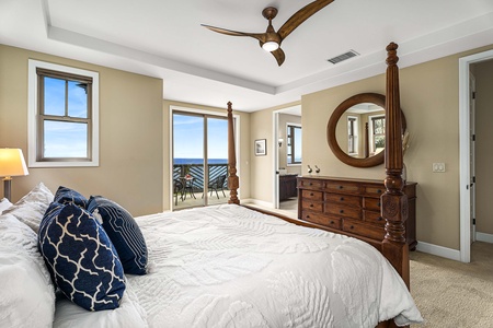 Spacious primary suite with seating area and panoramic ocean outlook.