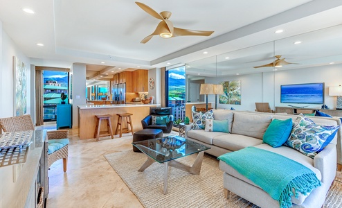 The living area offers plush sectional sofa and open floorplan to the kitchen for seamless flow and connection.