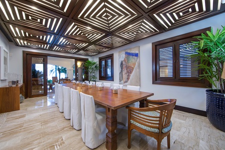 Sophisticated dining area with a striking ceiling design and a view of the outdoors.