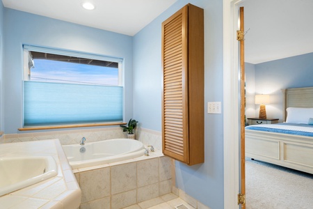 Sink into your private soaking tub and let ocean views wash your worries away in this serene master suite.