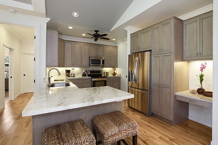 Cook with ease in the well-appointed kitchen with quartz counters, stainless steel appliances, and bar seating.