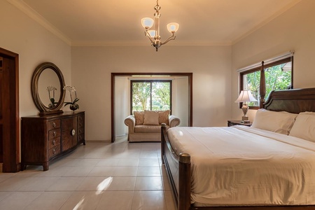 The guest bedroom also features a classic dresser and cozy reading nook.