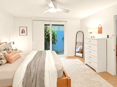 Unwind in your serene bedroom sanctuary with cozy bedding, thoughtful touches, and peaceful garden views from your private patio doors.