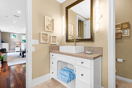 Bathroom with elegant mirror and charming vanity.