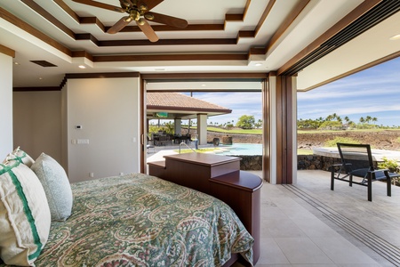 The primary suite opens directly to the pool deck—wake up to golden light and Big Island breezes.