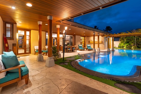 Evening view of pool courtyard and covered terrace.