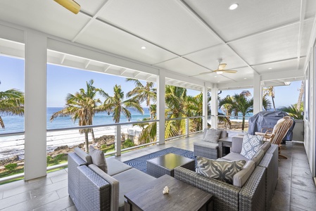 Spacious Oceanfront Luxury Dream Estate's upper lanai with plush seating and panoramic coastal views.