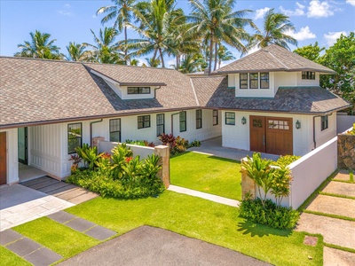 Private gated entry to the estate with tropical landscaping and generous parking.