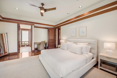 Primary bedroom showcasing lush garden views and natural light. This bedroom sits at the opposite end of the home from the other two guest suites, offering the ultimate in privacy and comfort.