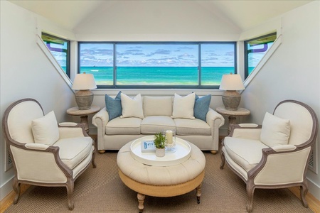 Second-story seating nook in the primary suite with unobstructed views of turquoise Kailua waters.