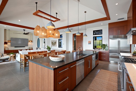 Spacious kitchen with a large island and modern lighting.