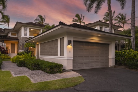 A beautiful tropical villa awaits beneath swaying palms and dramatic sunset skies.