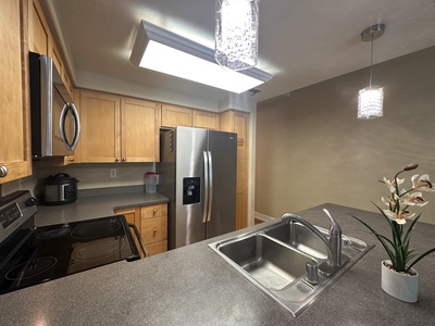 Fully stocked kitchen with stainless steel appliances and plenty of prep space.