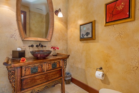 Rich wood vanity in the powder room.