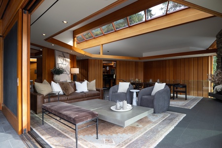 Stylish indoor lounge with warm wood tones and abundant natural light.