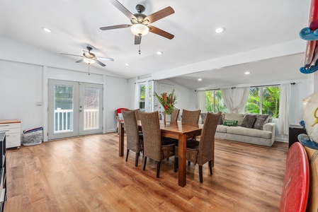 Spacious open floor plan seamlessly connects dining and living areas, with easy access to outdoor spaces for true island-style living.
