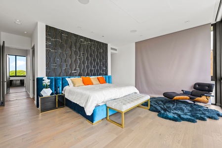 This chic guest suite features designer wall treatments, layered textiles, and generous glass doors opening to island air.