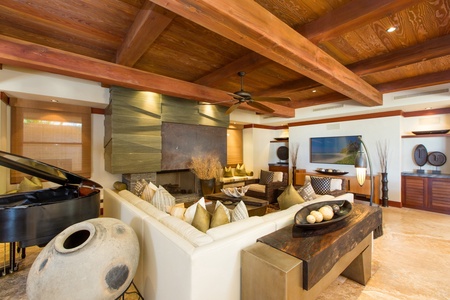 The great room opens toward the shoreline, creating a seamless connection to the ocean beyond.