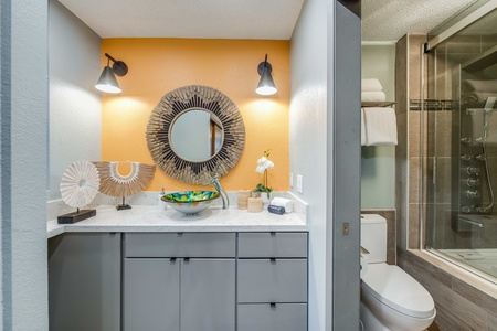 Bright and beachy ensuite vanity with plenty of counter space and a separate water closet for added privacy and ease.