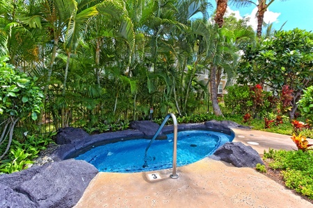 Relax in the luxurious hot tub by the community pool.