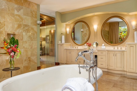 Indulge in spa-style relaxation with a soaking tub, dual vanities, and walk-in shower in the primary bath.