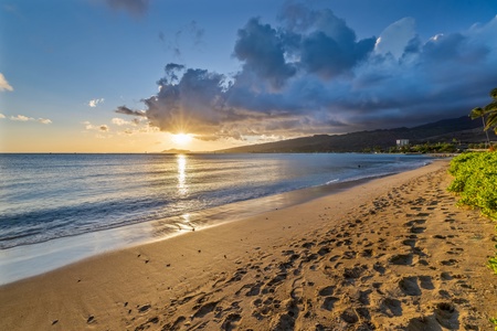 Stroll through the sandy beach at sunset.