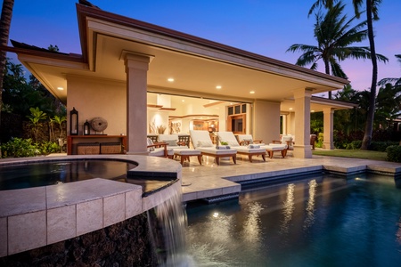 Angle on the private spa with waterfall feature into the infinity pool.