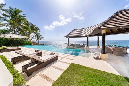 Enjoy a refreshing dip in the infinity pool or relax on the poolside chaise loungers.