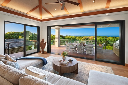 Relax in the cozy living room with expansive glass doors opening to serene outdoor views.