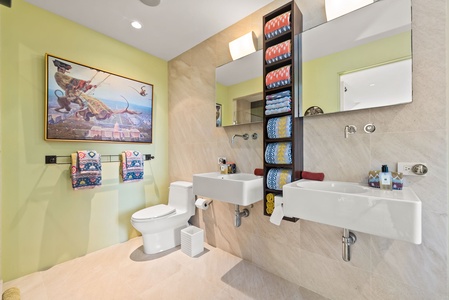 Bright and modern guest bathroom with double vanities and custom tile accents.
