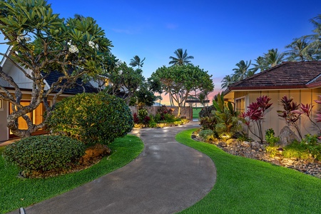 Spacious and inviting entrance surrounded by vibrant greenery.