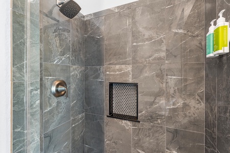 Walk-in shower with elegant tile—refresh after beach days in comfort and style.