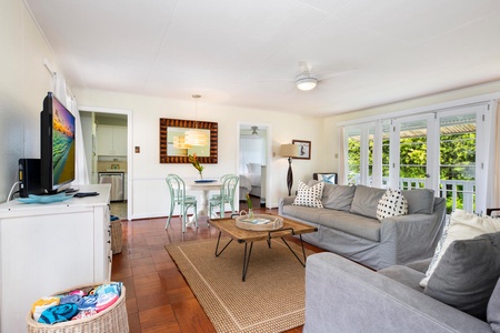 The bright and airy living room seamlessly connects to the front and backyard, offering easy indoor-outdoor living.