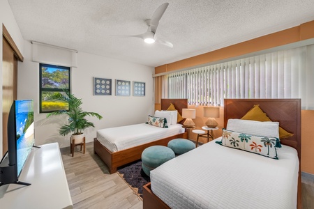 Sleep comfortably in this bright guest room with two beds, perfect for friends or family traveling together.