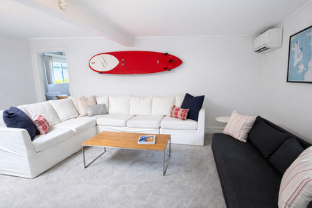 Spacious formal living area with a modern touch and plush seating, ideal for entertaining.