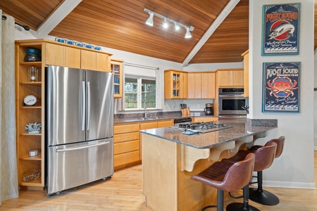 Your fully equipped kitchen welcomes culinary adventures with granite countertops, stainless appliances, and a breakfast bar for morning coffee.