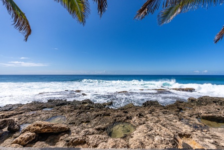 Soothing blues and volcanic textures meet where land and sea embrace—your daily ocean soundtrack.
