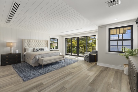 Secondary primary suite with queen bed, lanai access, and sweeping ocean views for a serene escape.
