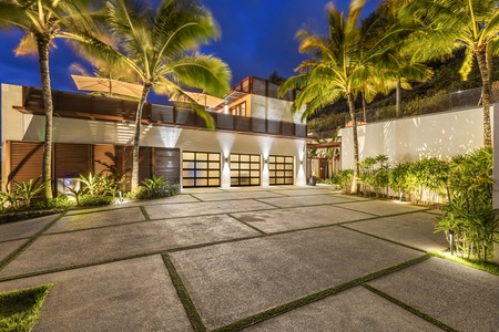 A grand driveway with ample parking, leading to the entrance of this luxury estate.
